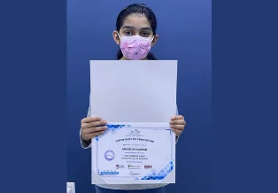 Brainy n Bright learner holding a certificate