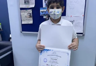 Brainy n Bright learner celebrating a certificate