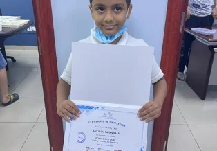 Brainy n Bright learner holding a certificate