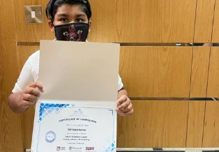Brainy n Bright learner receiving a certificate